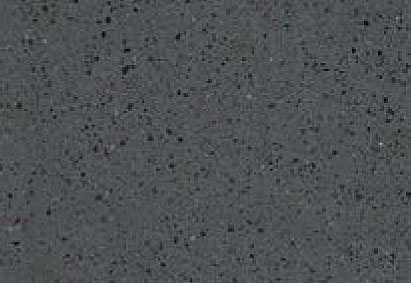 Close-up of a textured surface with a speckled pattern, predominantly in shades of gray with some minute flecks of white and black.